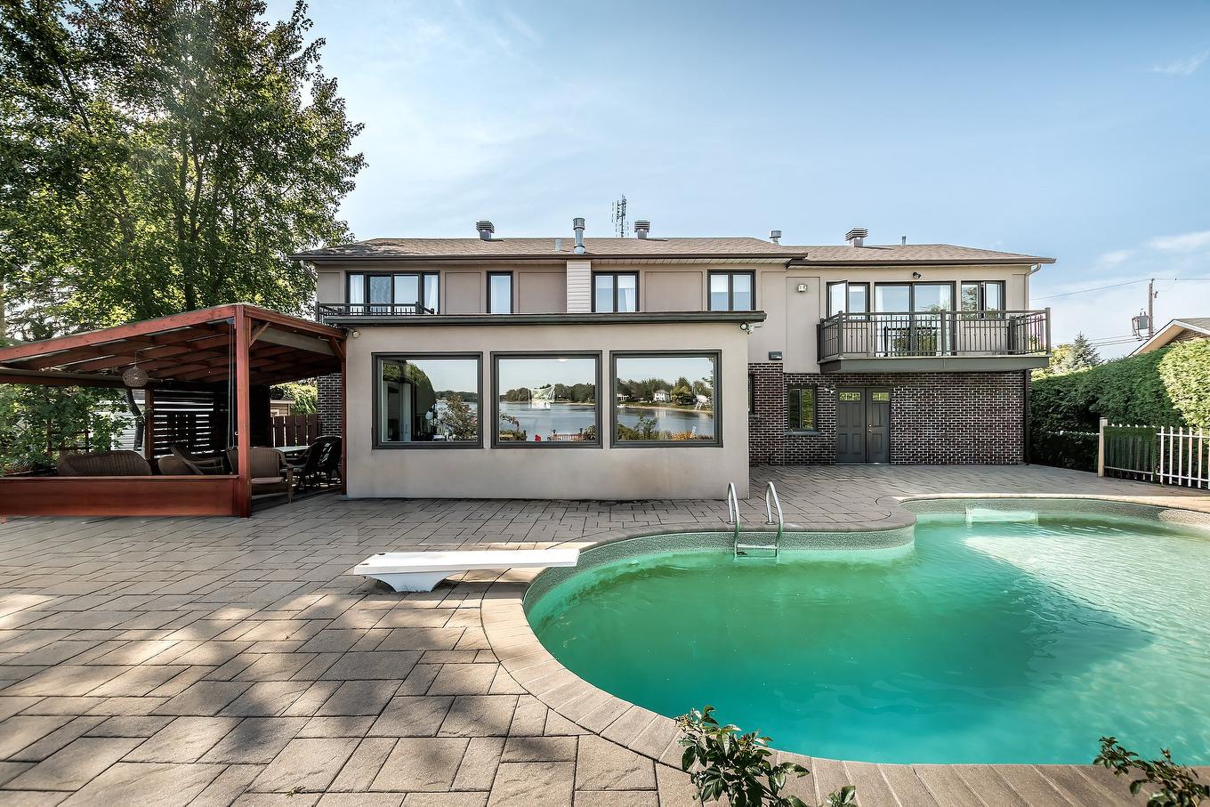 Face arrière - 15215 Place Bellerive, Montréal (L'Île-Bizard/Sainte-Geneviève), QC - Outdoor With In Ground Pool With Deck Patio Veranda