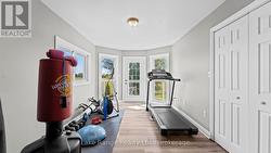 Gym or hobby area with balcony in primary bedroom -