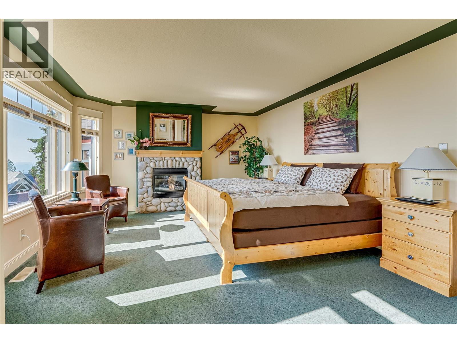 635 Monashee Road Unit# 8, Silver Star, BC - Indoor Photo Showing Bedroom With Fireplace