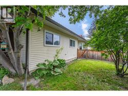 BACK YARD - Looking towards front door on East side of home. -
