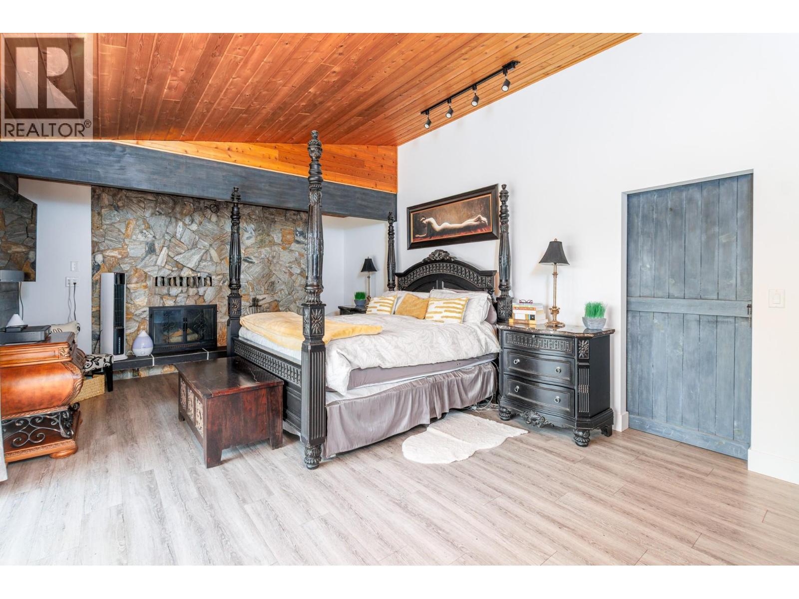 6171 50 Street Nw, Salmon Arm, BC - Indoor Photo Showing Bedroom With Fireplace