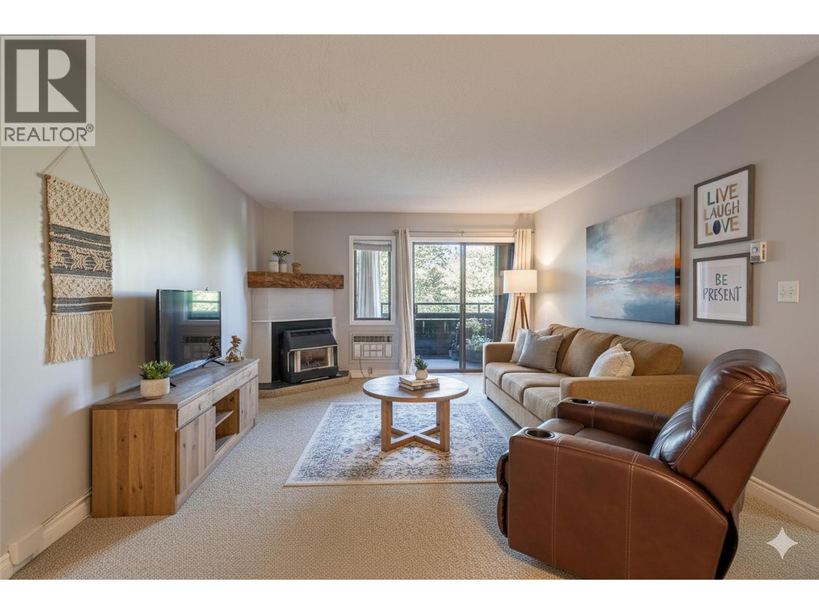 unit #203 virtual staged Living room - 1801 32 Street Unit# 203, Vernon, BC - Indoor Photo Showing Living Room With Fireplace