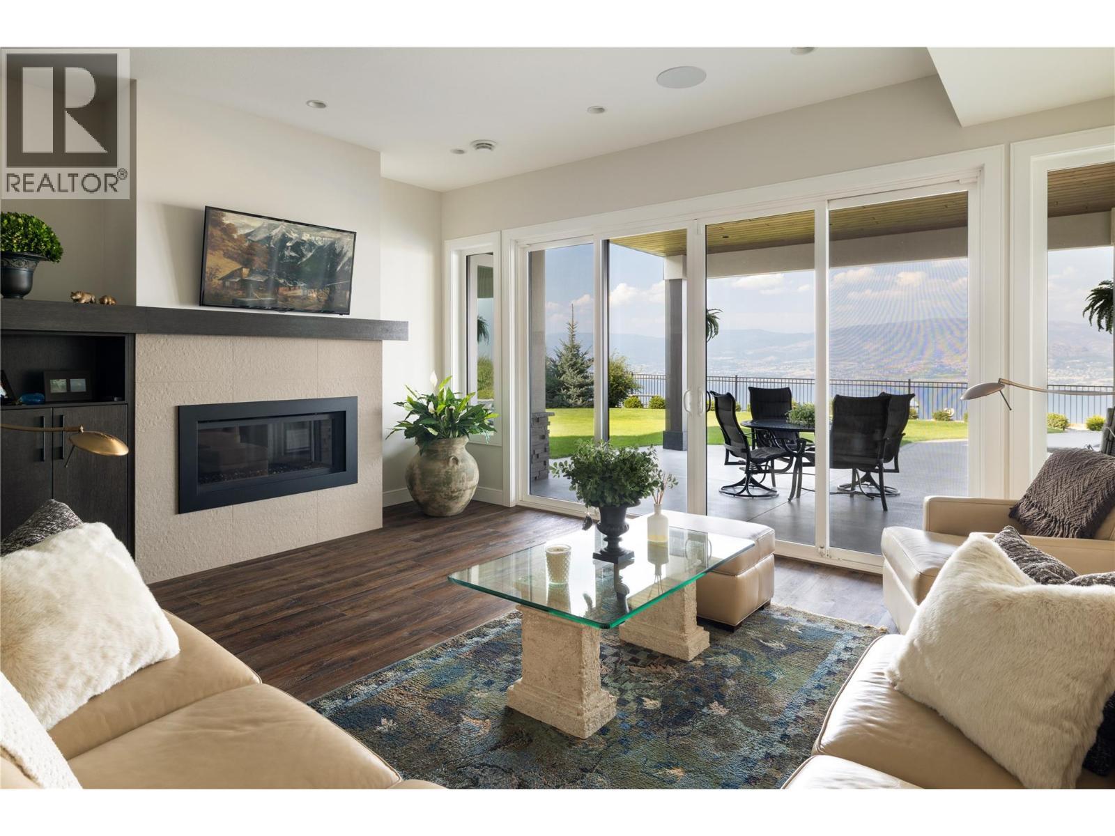 Lwr level family rm - 5572 Upper Mission Drive, Kelowna, BC - Indoor Photo Showing Living Room With Fireplace