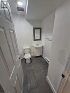 Half bathroom with vanity and a baseboard radiator -