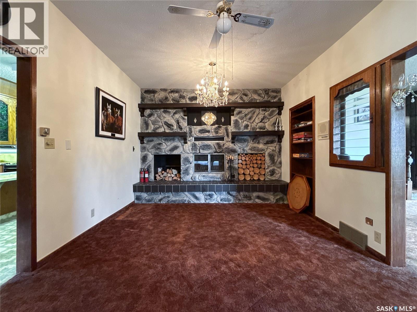 107 Centre Street, Kincaid, SK - Indoor Photo Showing Other Room With Fireplace