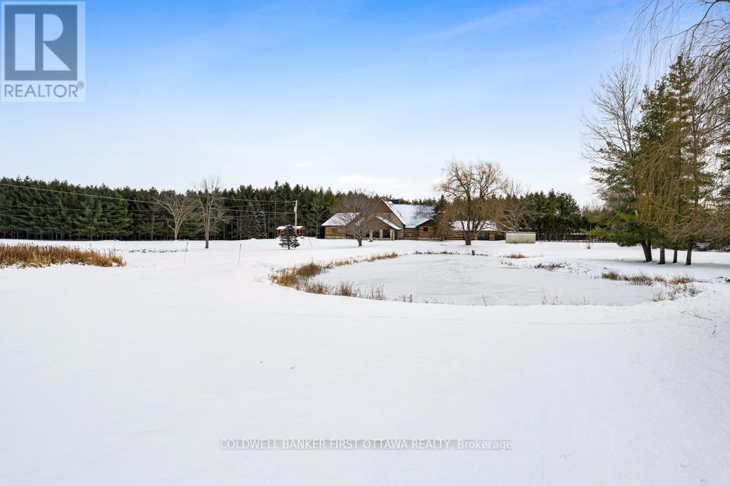 Pond with graceful flowing fountain in the summers - 2499 Bathurst Concession 2 Road, Tay Valley, ON - Outdoor With View