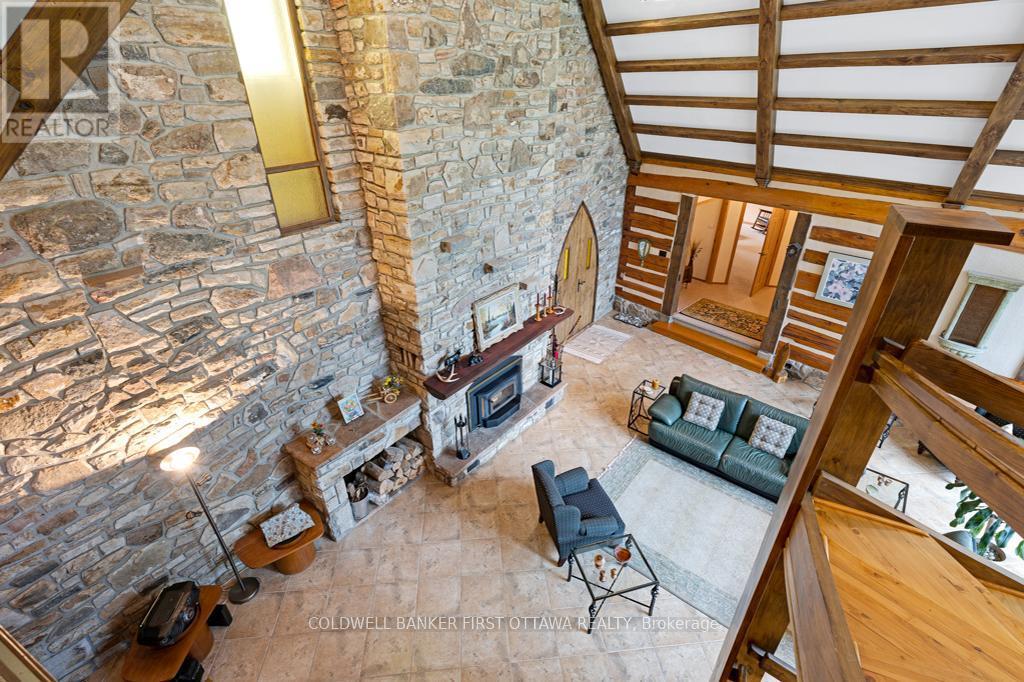 Soaring ceilings and ceramic floor - 2499 Bathurst Concession 2 Road, Tay Valley, ON - Indoor Photo Showing Other Room With Fireplace