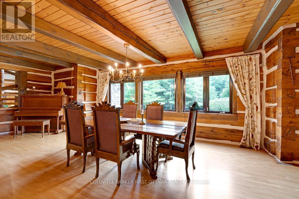 Wall of windows overlook tranquil outdoors - 2499 Bathurst Concession 2 Road, Tay Valley, ON - Indoor Photo Showing Dining Room