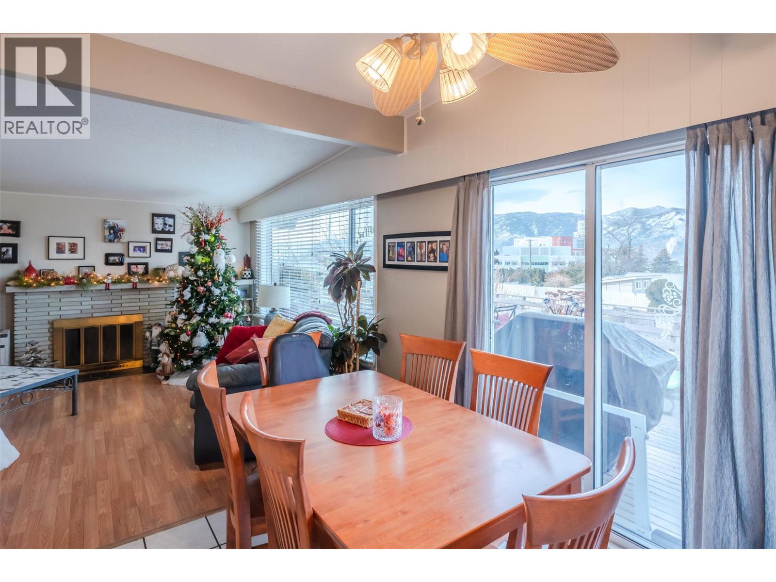 1467 Carmi Drive, Penticton, BC - Indoor Photo Showing Dining Room With Fireplace