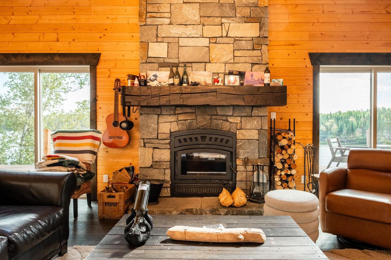 63 S Poplar Bay, District Of Kenora, ON - Indoor Photo Showing Living Room With Fireplace