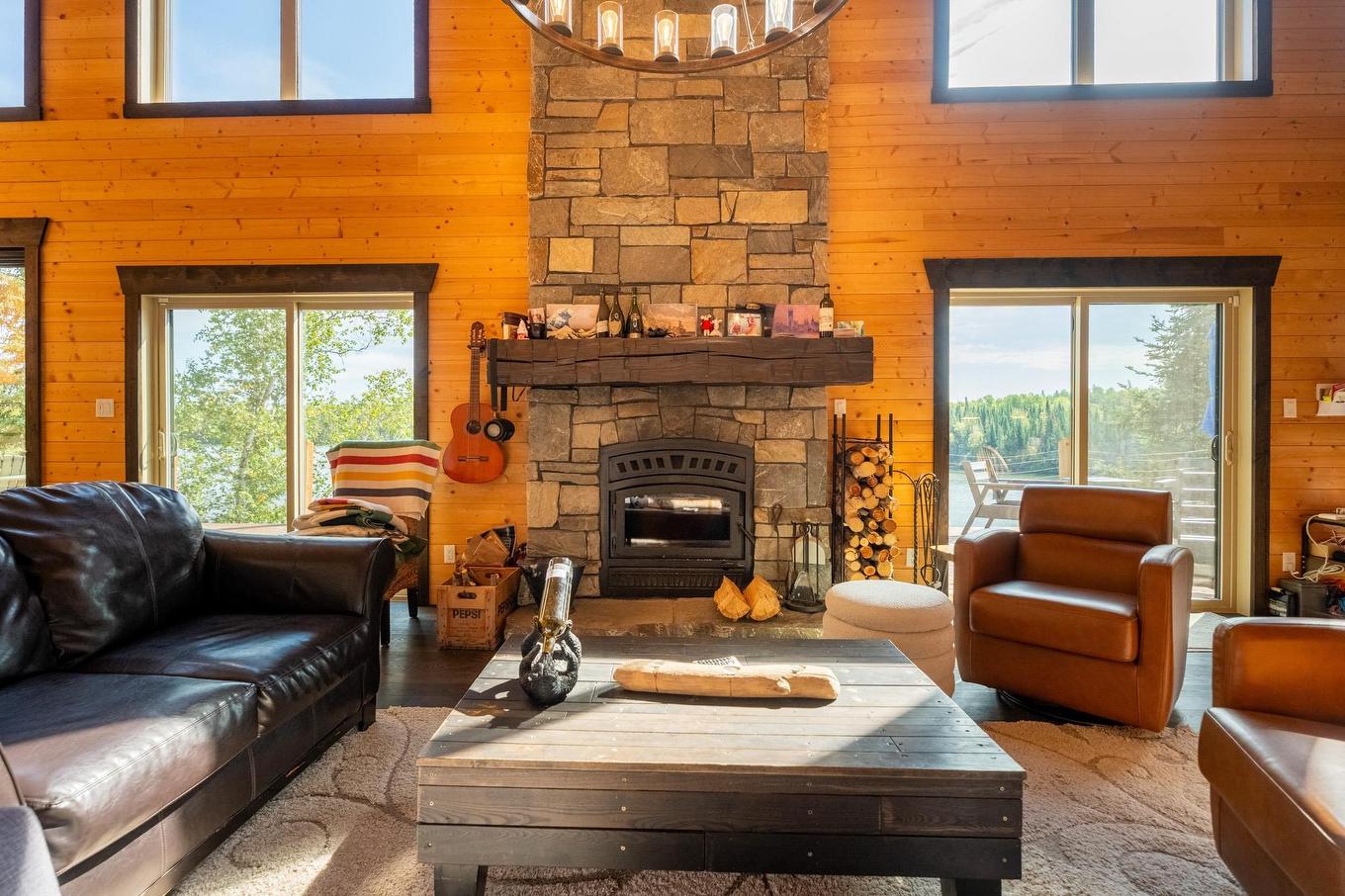63 S Poplar Bay, District Of Kenora, ON - Indoor Photo Showing Living Room With Fireplace