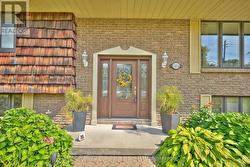 Welcoming front entrance with gardens -