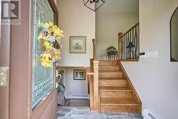 Hardwood stairs from the foyer leading up and down -
