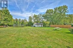Expansive backyard with fence and garden shed -