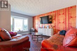 Living Room: Large bay window, laminate floors. -