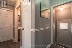 Hallway to basement and side door entrance. -