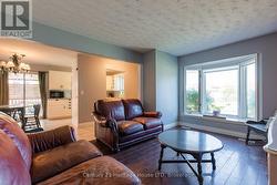 Living Room: Large bay window, laminate floors. -