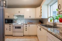 Kitchen featuring wine rack tile backsplash. -