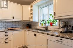 Kitchen featuring wine rack tile backsplash. -