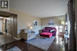 Living area featuring dark wood-style floors and a textured ceiling -