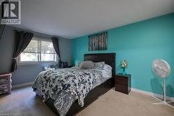 Bedroom featuring baseboards and carpet -