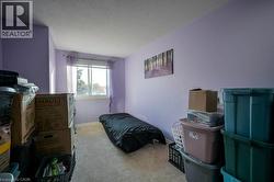 Bedroom with light colored carpet and a textured ceiling -