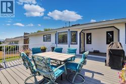 Large, newer deck with stairs down to the yard -