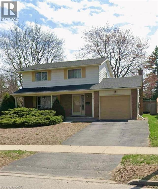 Traditional-style house featuring a garage, a porch, and asphalt driveway - 389 Dunvegan Drive, Waterloo, ON - Outdoor With Facade