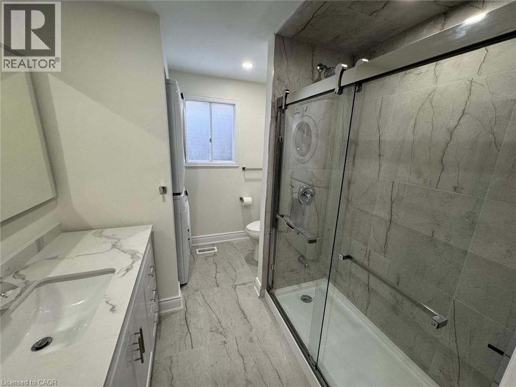 Full bath featuring vanity, a marble finish shower, recessed lighting, and washer / clothes dryer - 389 Dunvegan Drive, Waterloo, ON - Indoor Photo Showing Bathroom
