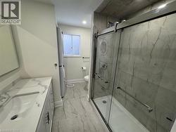 Full bath featuring vanity, a marble finish shower, recessed lighting, and washer / clothes dryer -
