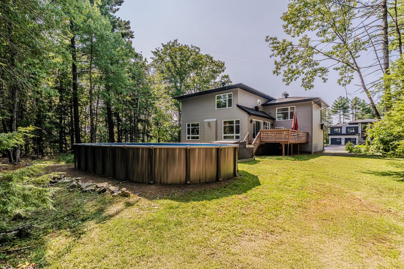 Back facade - 16925 Rue Du Corail, Mirabel, QC - Outdoor With Above Ground Pool With Backyard With Exterior