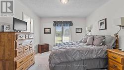 Primary Bedroom overlooking rear green space -