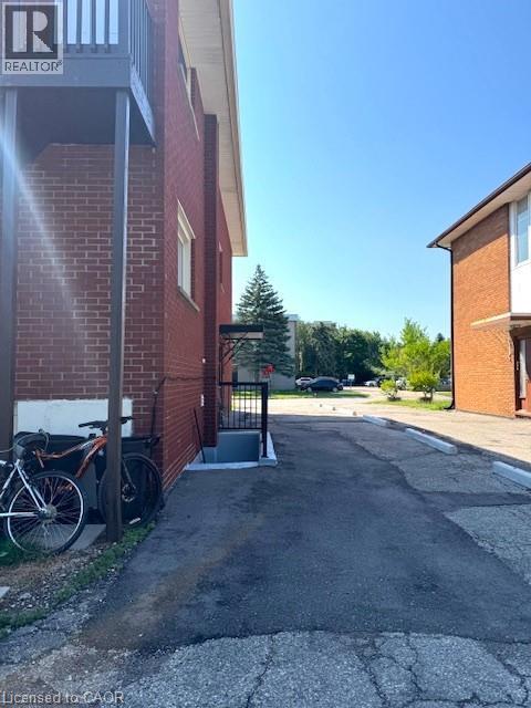 View of home's exterior featuring brick siding - 106 Chandler Drive Unit# 1, Kitchener, ON - Outdoor