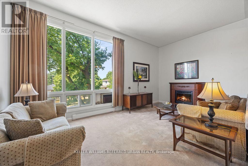 2 Sebastian Cabot Way, Toronto, ON - Indoor Photo Showing Living Room With Fireplace