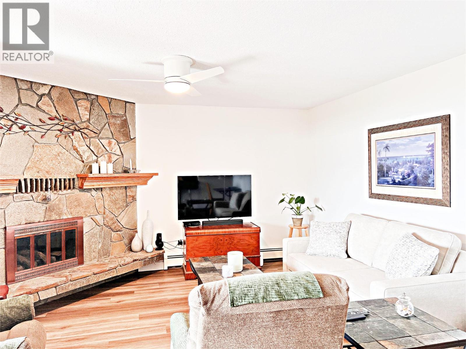 4340A Beach Avenue Unit# 102, Peachland, BC - Indoor Photo Showing Living Room With Fireplace