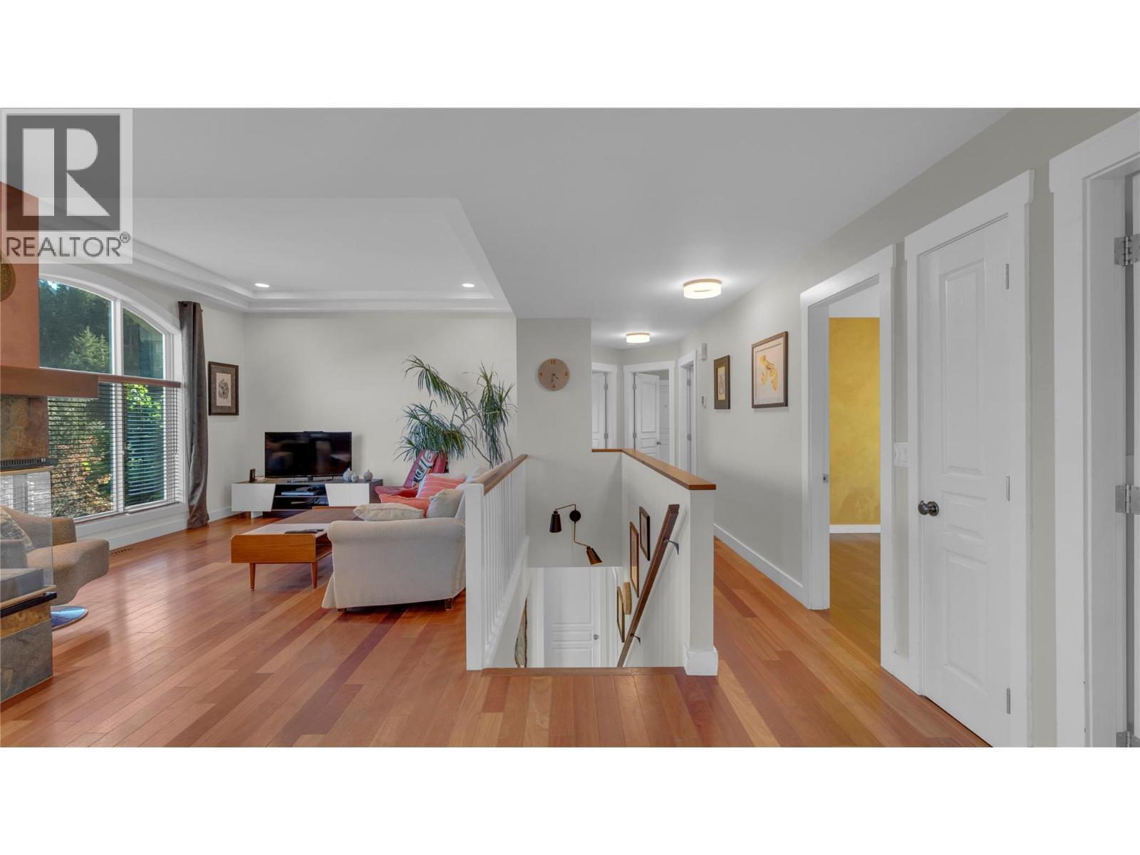MAIN FLOOR - Living Room & Stairs to Foyer Below - 3065 Lakeview Cove Road, West Kelowna, BC - Indoor With Fireplace