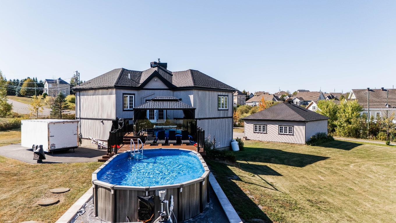 Face arrière - 1049 Rue Des Chevaliers, Prévost, QC - Outdoor With Above Ground Pool