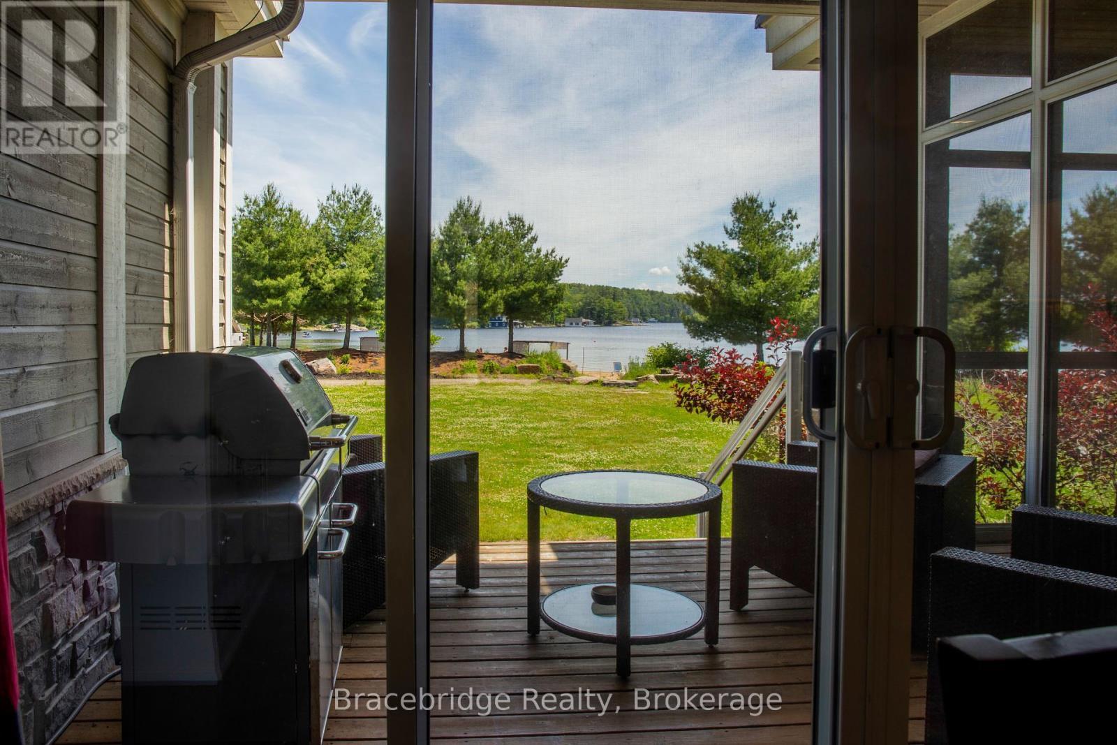 G103-D1 - 1869 Muskoka 118 Highway W, Muskoka Lakes (Monck (Muskoka Lakes)), ON - With Body Of Water With Exterior