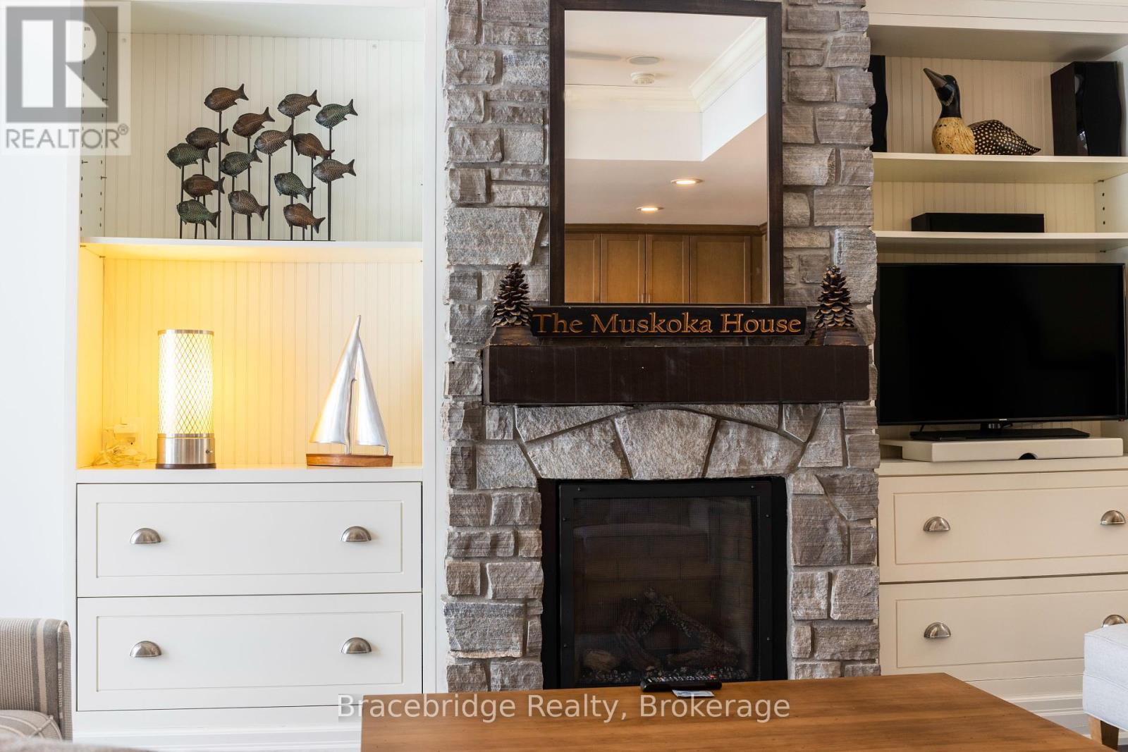 G103-D1 - 1869 Muskoka 118 Highway W, Muskoka Lakes (Monck (Muskoka Lakes)), ON - Indoor Photo Showing Other Room With Fireplace