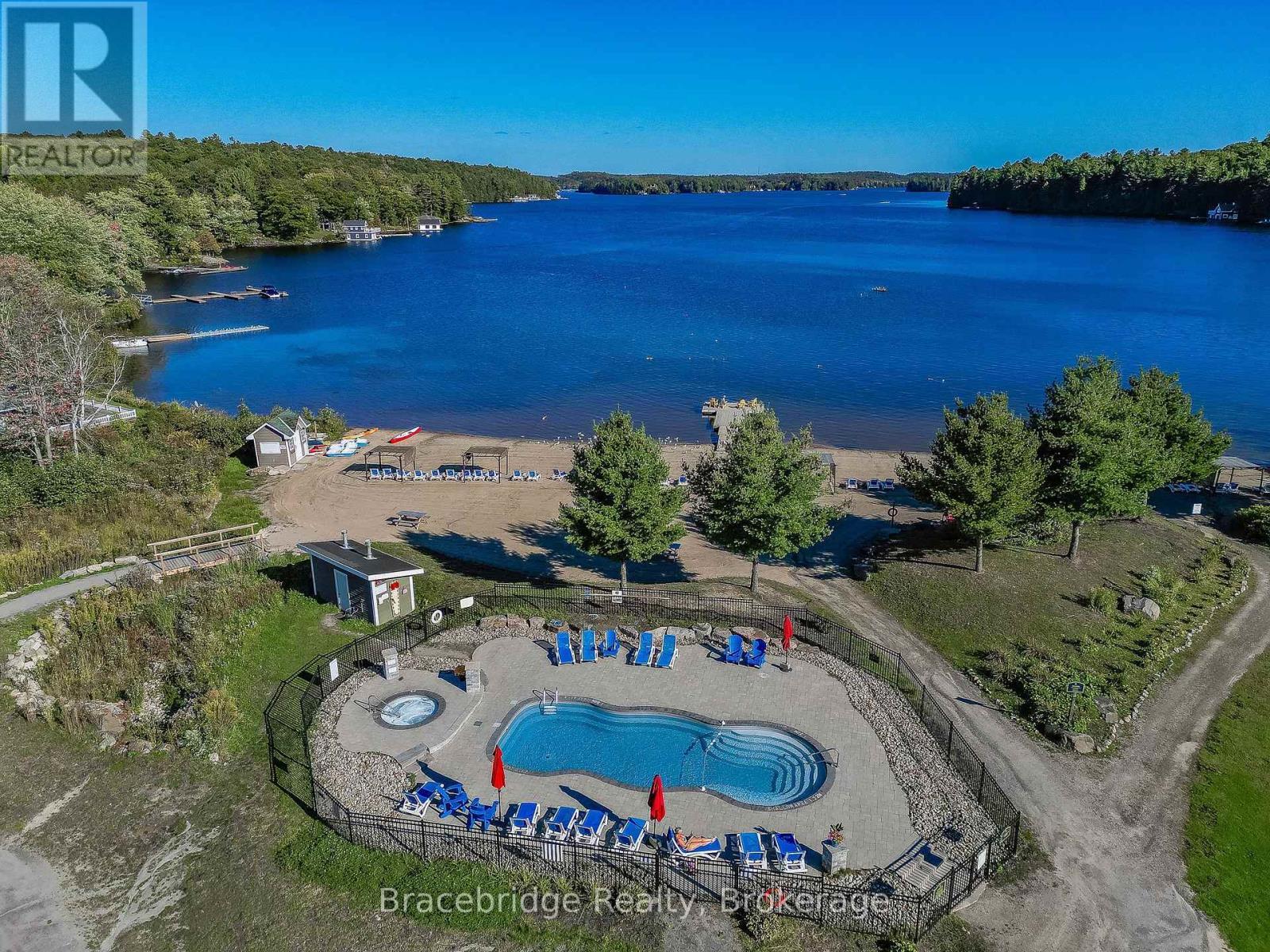 G103-D1 - 1869 Muskoka 118 Highway W, Muskoka Lakes (Monck (Muskoka Lakes)), ON - Outdoor With Body Of Water With In Ground Pool With View