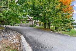 Driveway to triple car garage and house -