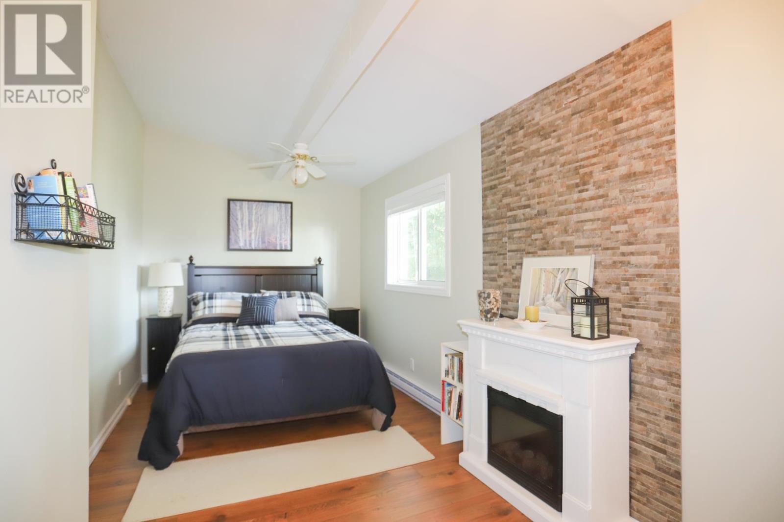 647B Lakeshore Dr, Tarbutt, ON - Indoor Photo Showing Bedroom With Fireplace