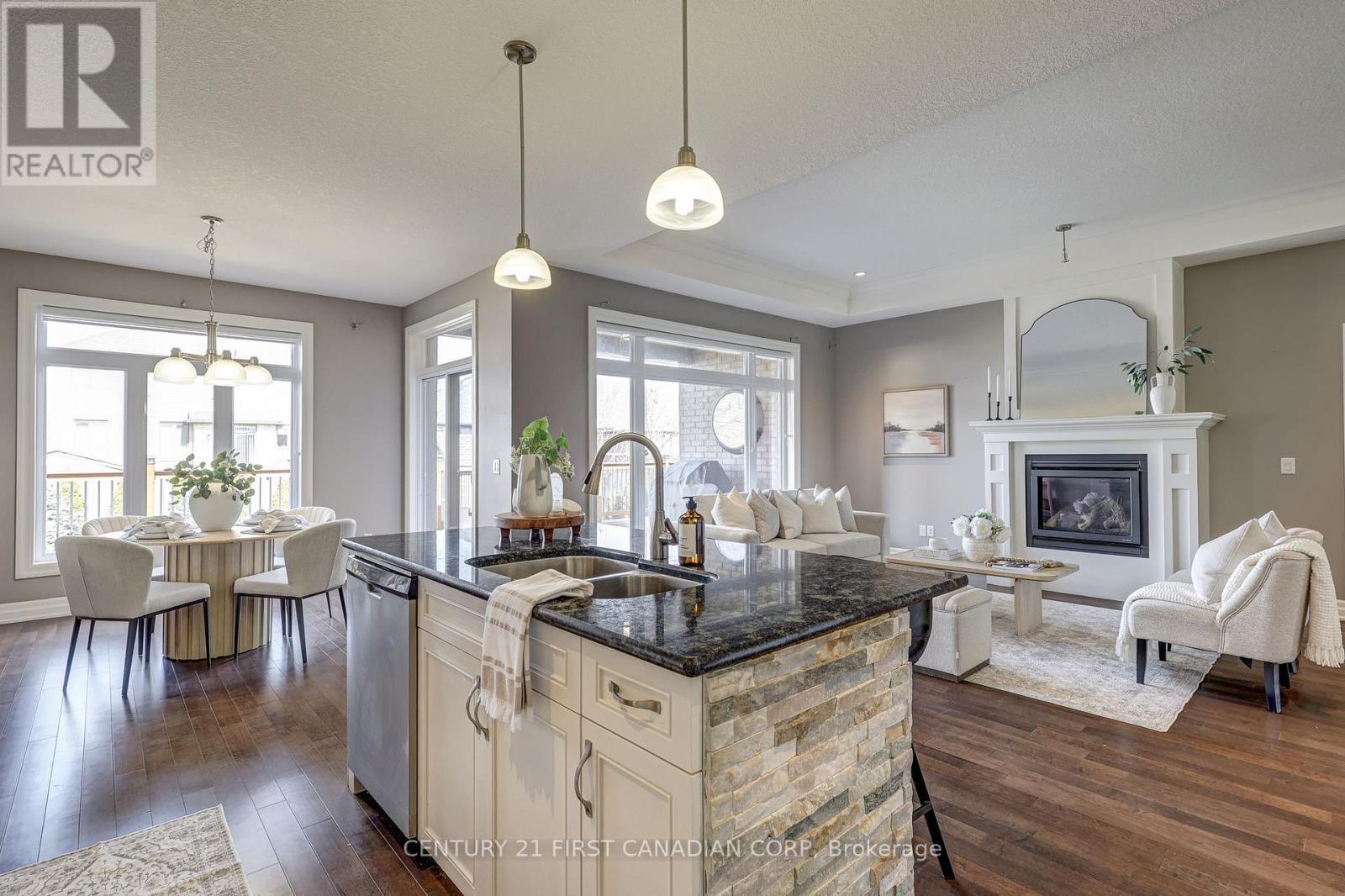 696 Bennett Crescent, Strathroy-Caradoc (Mount Brydges), ON - Indoor Photo Showing Kitchen With Fireplace With Double Sink With Upgraded Kitchen