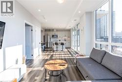 Living area featuring dark wood finished floors and recessed lighting -