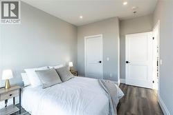 Bedroom featuring dark wood-style flooring and recessed lighting -