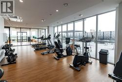 Workout area featuring expansive windows, light wood-style floors, and recessed lighting -
