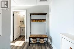 Mudroom featuring dark wood-type flooring and baseboards -