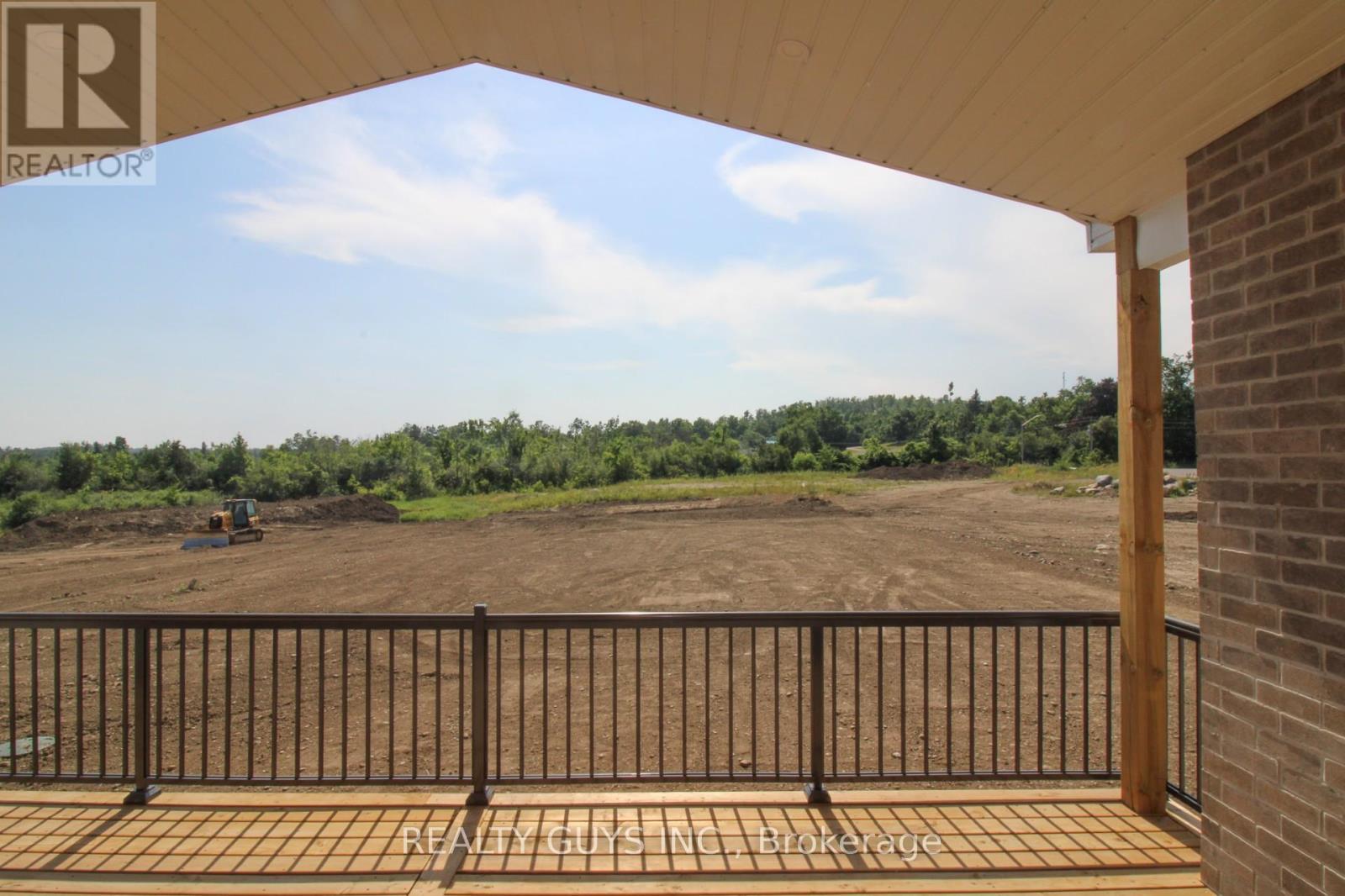 REAR COVERED DECK TO HUGE REAR YARD - 2418 Gwendolyn Court, Cavan Monaghan (Cavan Twp), ON - Outdoor With Deck Patio Veranda With View