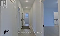 HALLWAY TO PRIMARY BEDROOM, LAUNDRY, GARAGE AND LL -