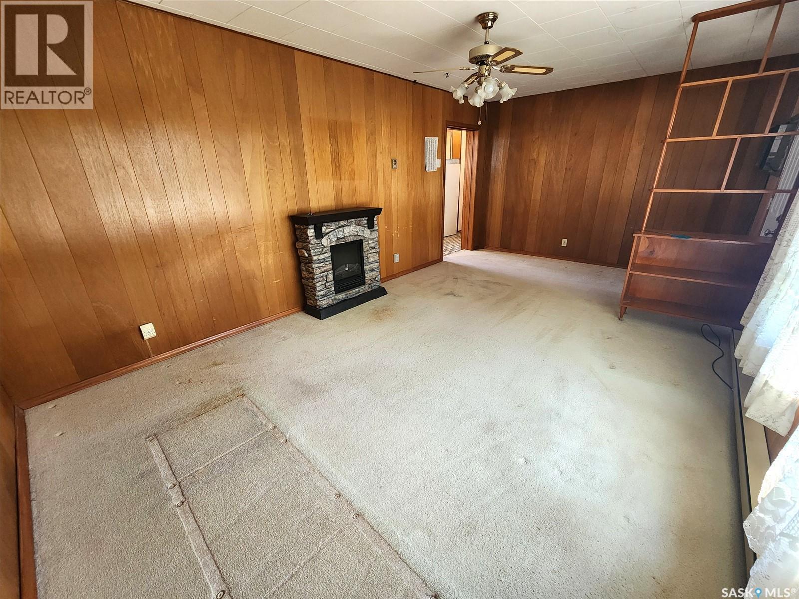 208 2Nd Avenue E, Lampman, SK - Indoor Photo Showing Other Room With Fireplace